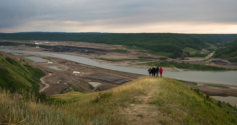 5 people stand on a hill at the Site C Dam
