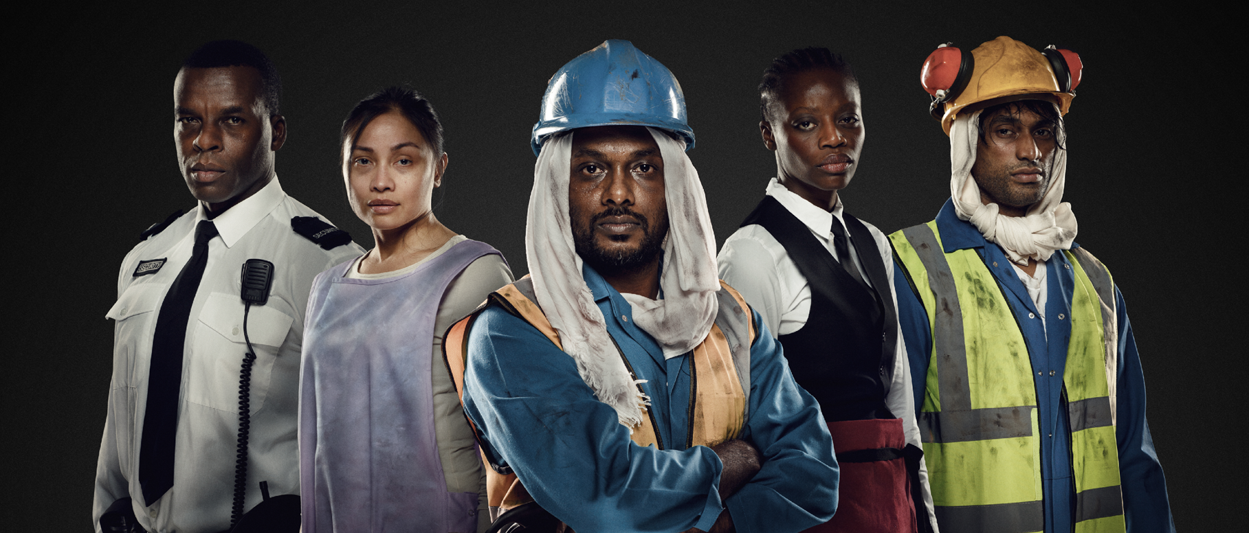 From left to right: A security guard, cleaner, construction working, waiter, and another construction worker pose shoulder to shoulder facing the camera.