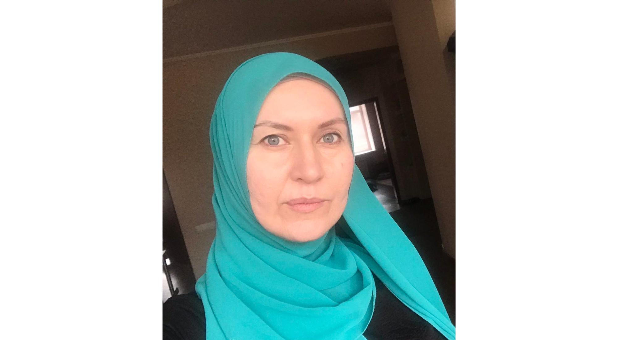 Lilia Hemedzhy wearing a green hijab over a black dress.