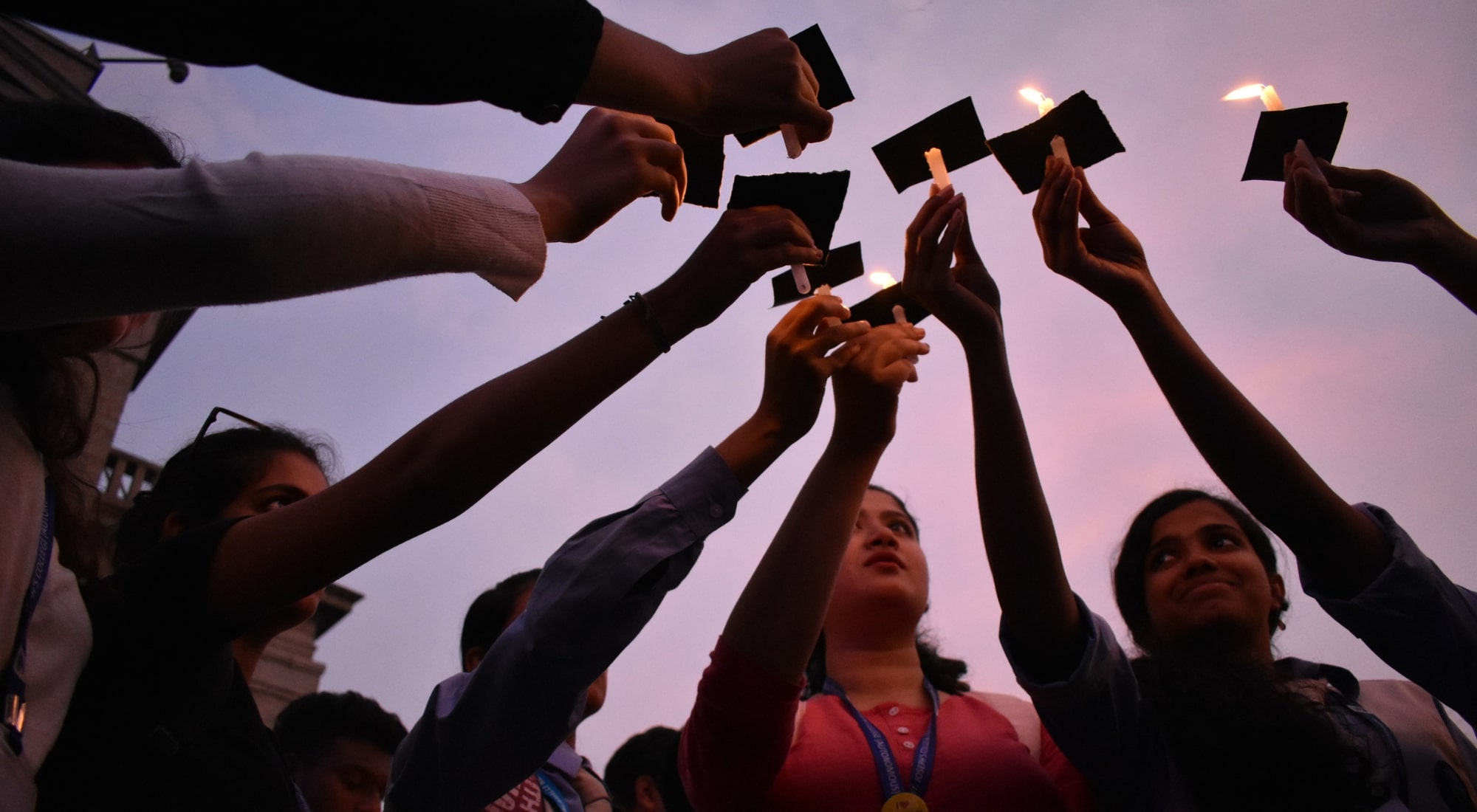 women hold up candles at march for Human Rights in Bangalore in 2018