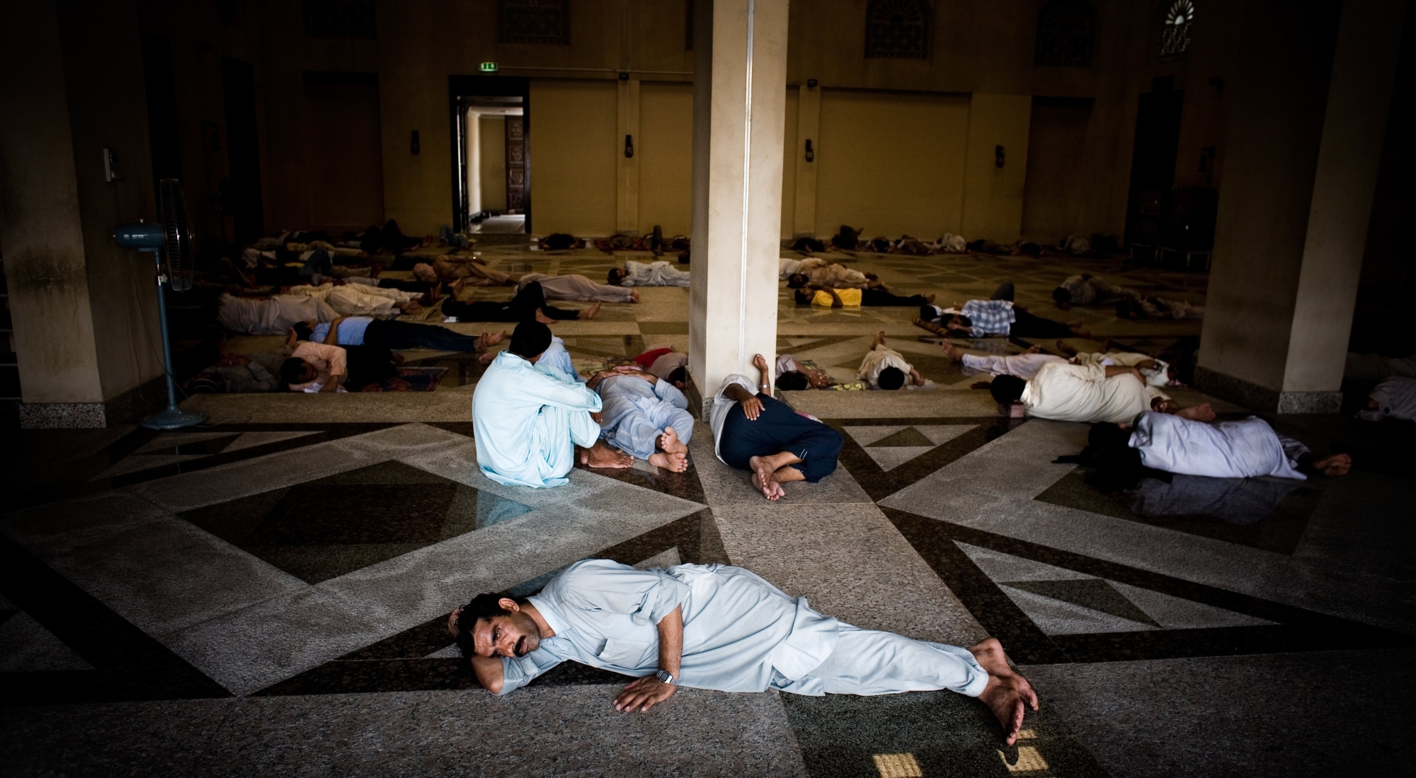 Migrant workers sleep in the streets July 7, 2008 Dubai, United Arab Emirates. Exploitation of hundreds of thousands of underpaid migrant workers, from countries such as India and Pakistan, help fuel the economic boom in construction and tourism in the small oil-rich Gulf State. Workers live and work in difficult conditions without adequate rights. (Photo by Ghaith Abdul Ahad/Getty Images)