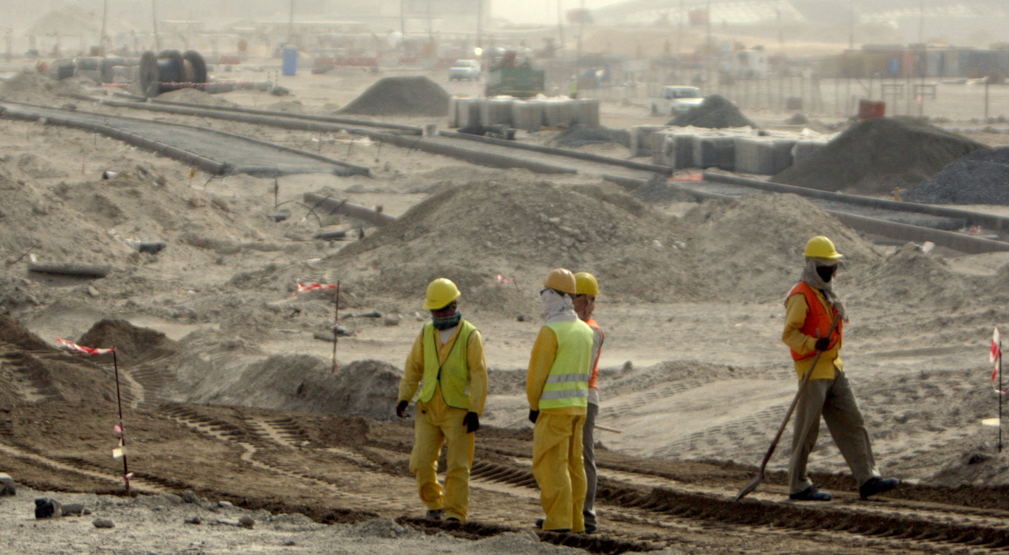 Foreign workers go ahead with their work at a construction site in Saadiyat island off Abu Dhabi during a tour organised for journalists on May 17, 2009 by the Gulf emirate's Tourism Development and Investment Company (TDIC). The tour came as Human Rights Watch accused the Abu Dhabi authorities and global institutions of failing to tackle abuse of foreign workers and called for contractual guarantees from construction firms. (Photo by Karim Sahib/AFP via Getty Images)