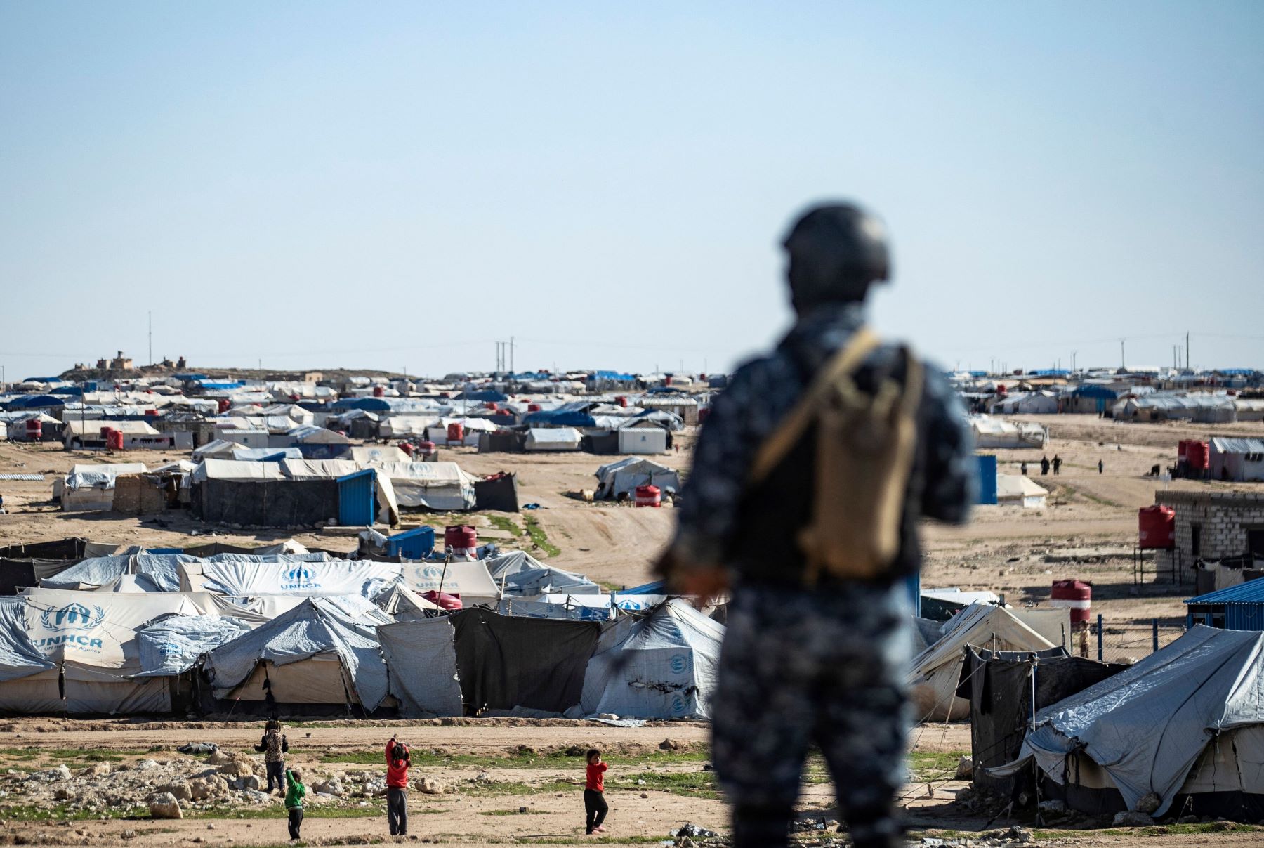 Special forces of the Syrian Democratic Forces keep watch on March 30, 2021 in the vicinity of al-Hol camp, the larger of two Kurdish-run displacement camps for relatives of Islamic State jihadists in Syria's northeast. Photo by DELIL SOULEIMAN/AFP via Getty Images.