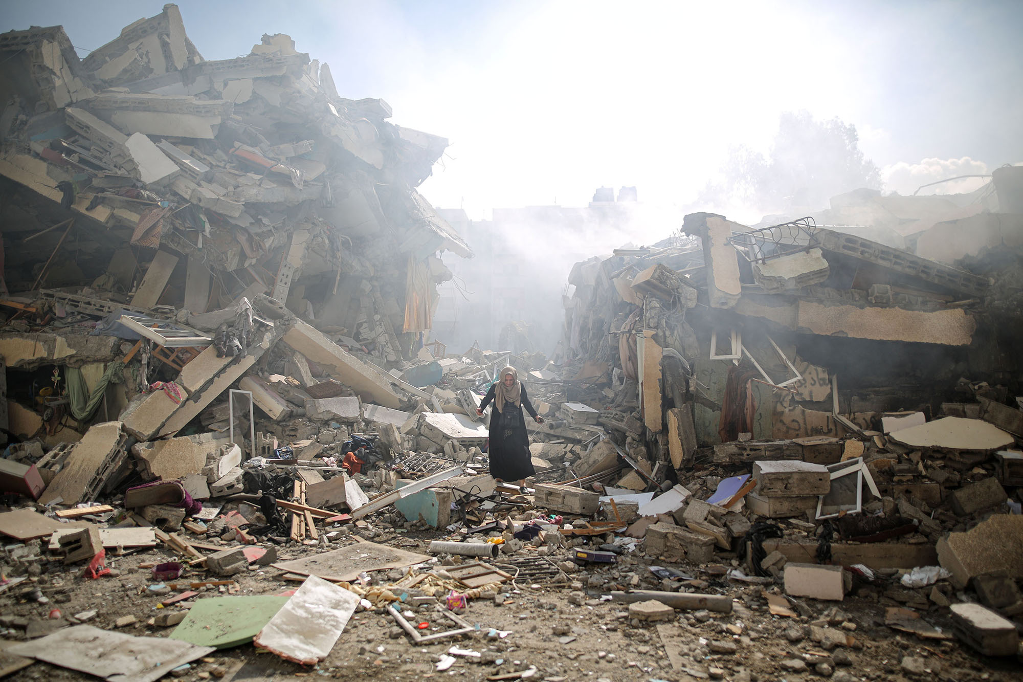 A woman walking through the rubble in Gaza