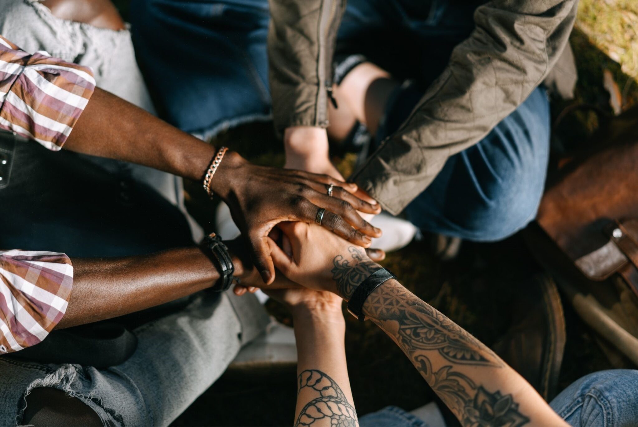 Hands together in a circle team meetings