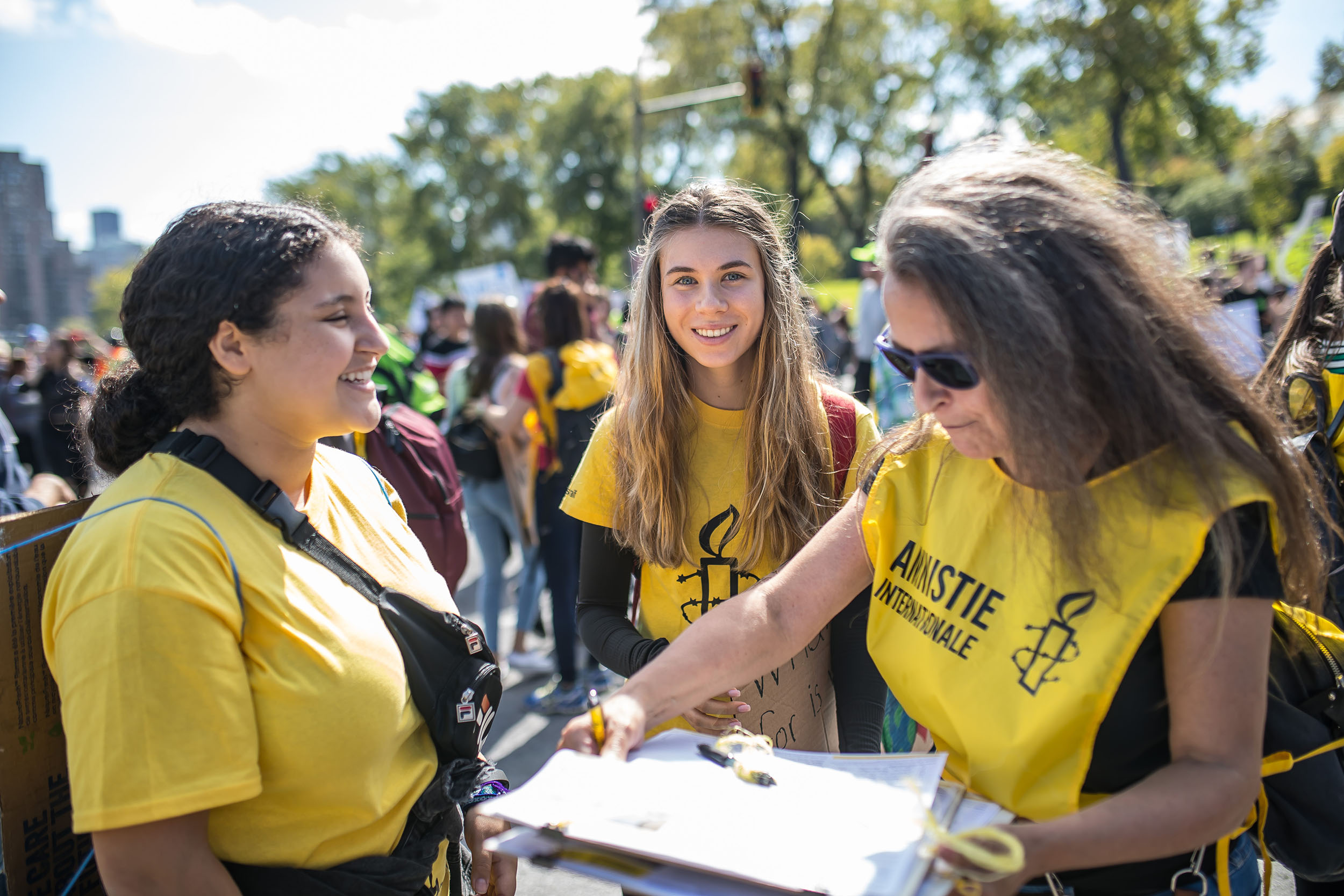 3 Amnesty volunteers working at an event outside