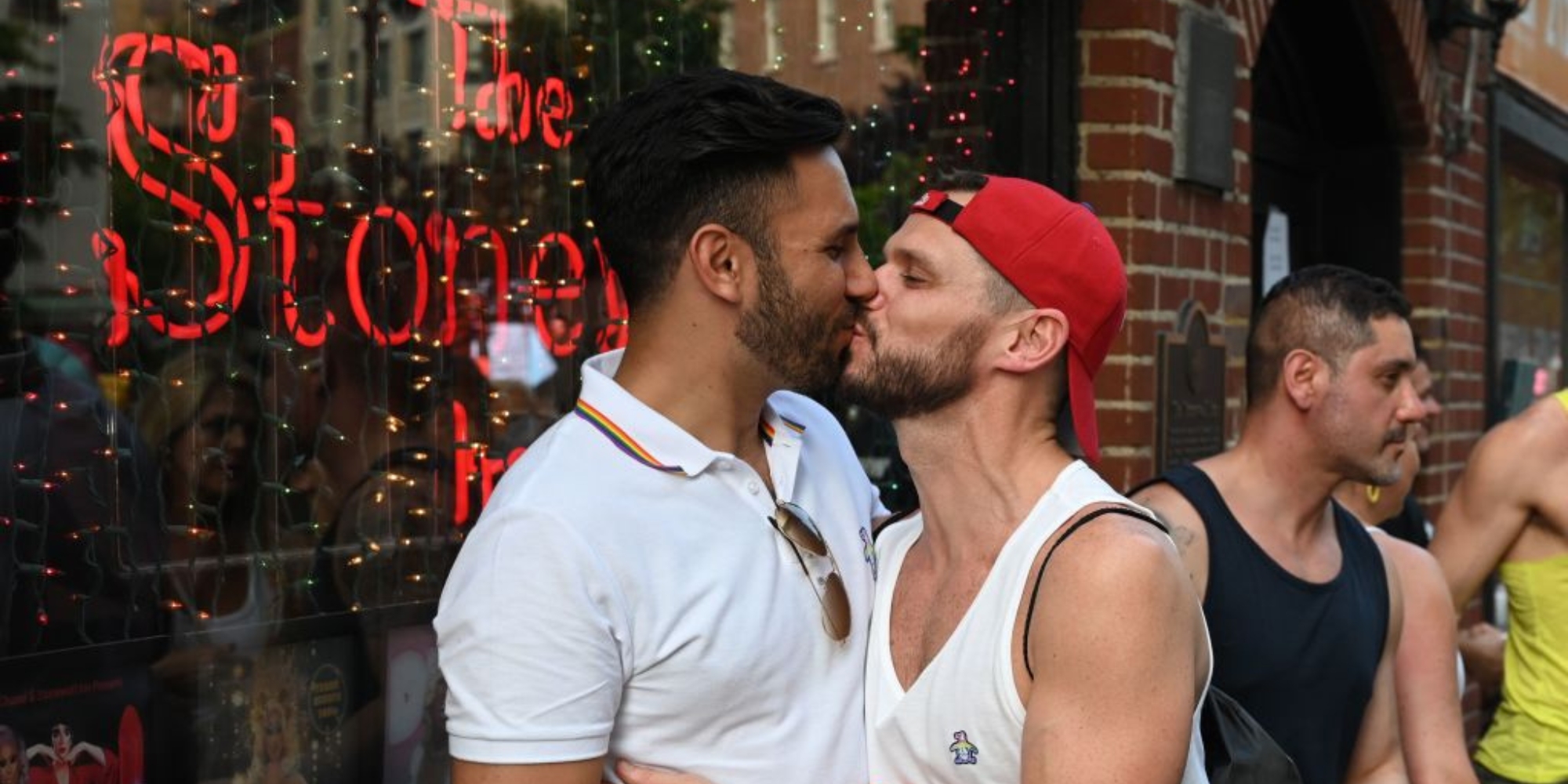 People kiss as they gather for the 50th anniversary of the Stonewall Riots in front of the Stonewall Inn in New York, June 28, 2019.