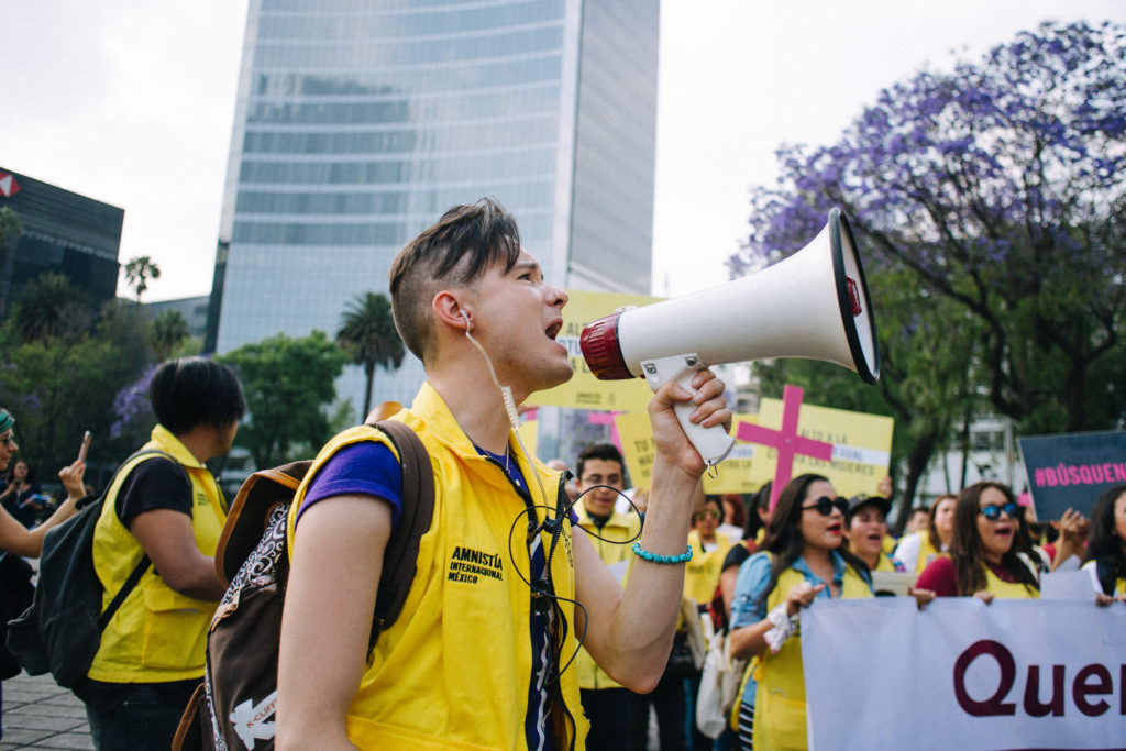 Amnesty International supporter talking into megaphone