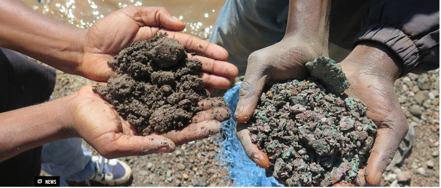 Two sets of hands, each clasped together holding a small mound of dirt.