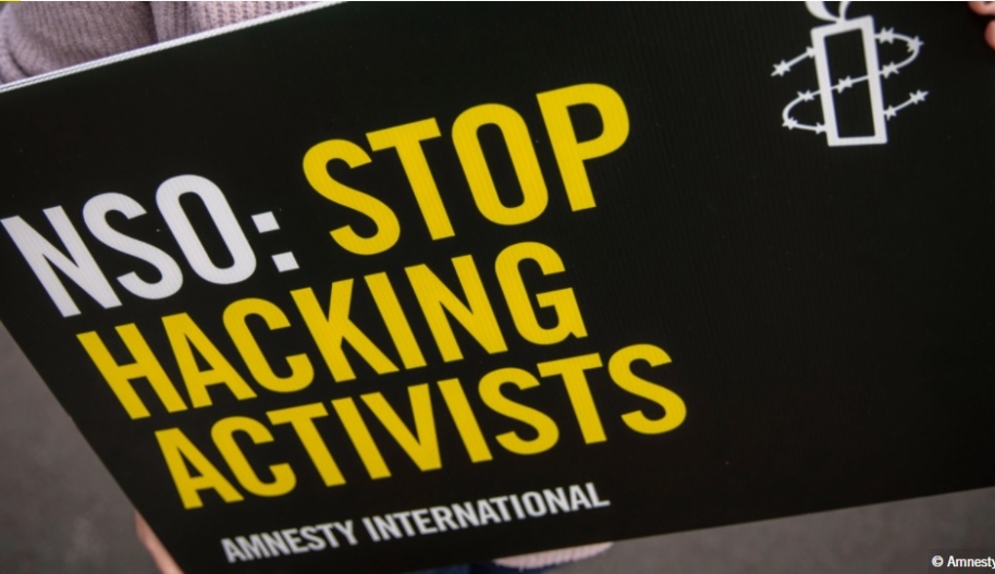 Text on sign says NSO: Stop Hacking Activists
