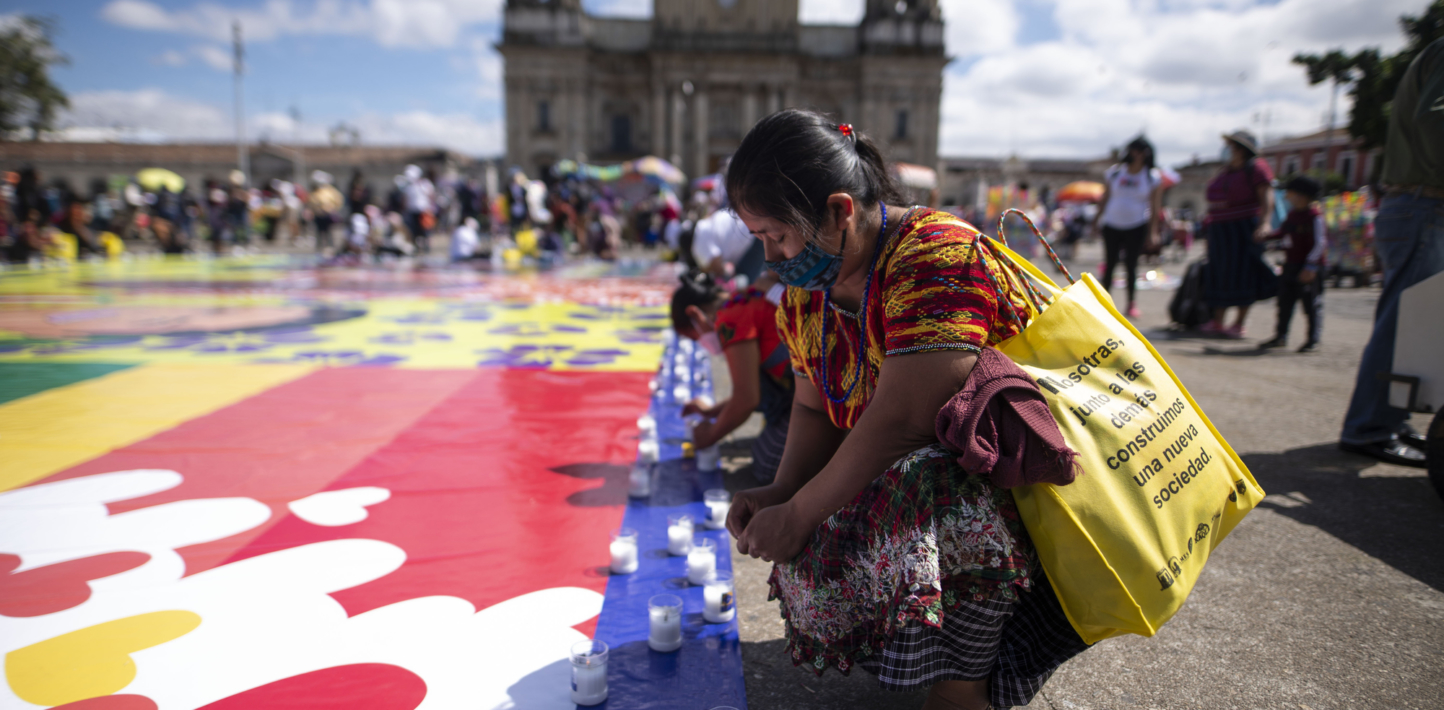 Women light candles outside Guatemalan Congress