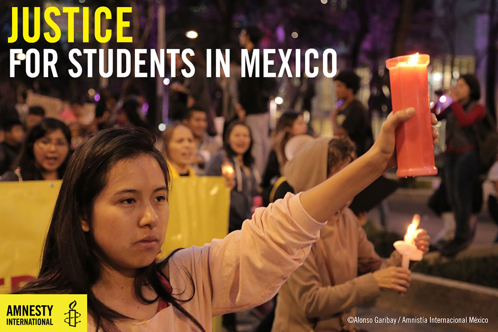 people march with candles for disappeared students