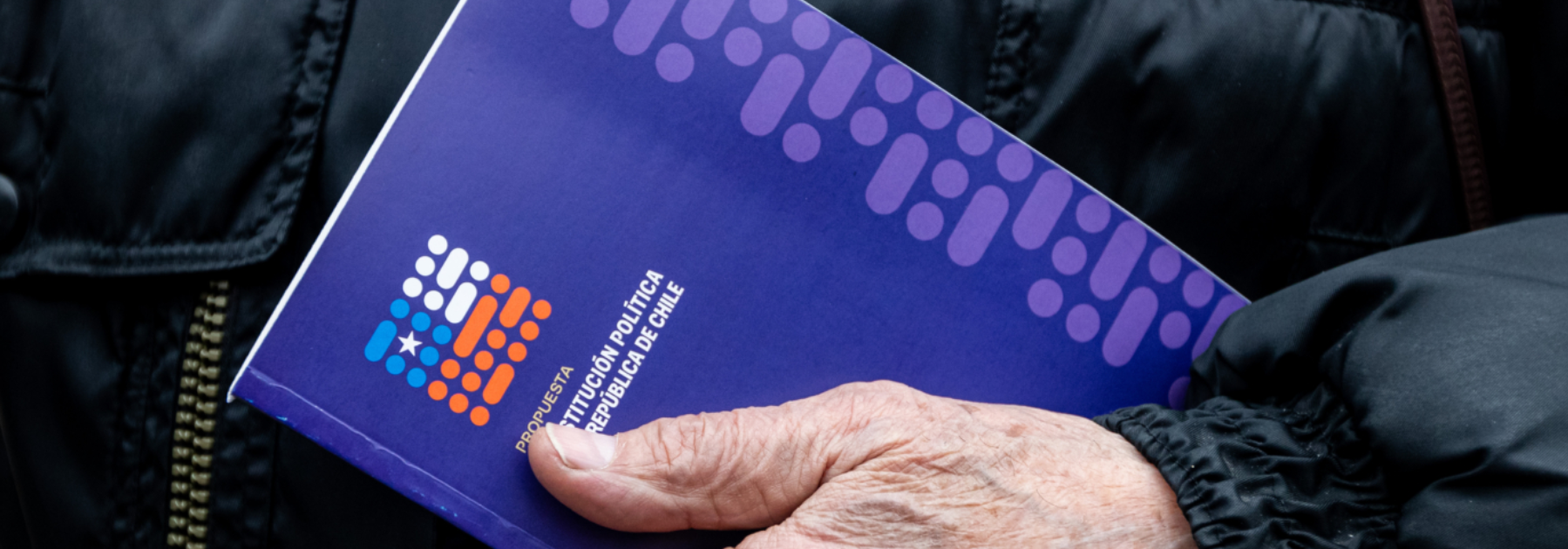 hand holds proposed new constitution