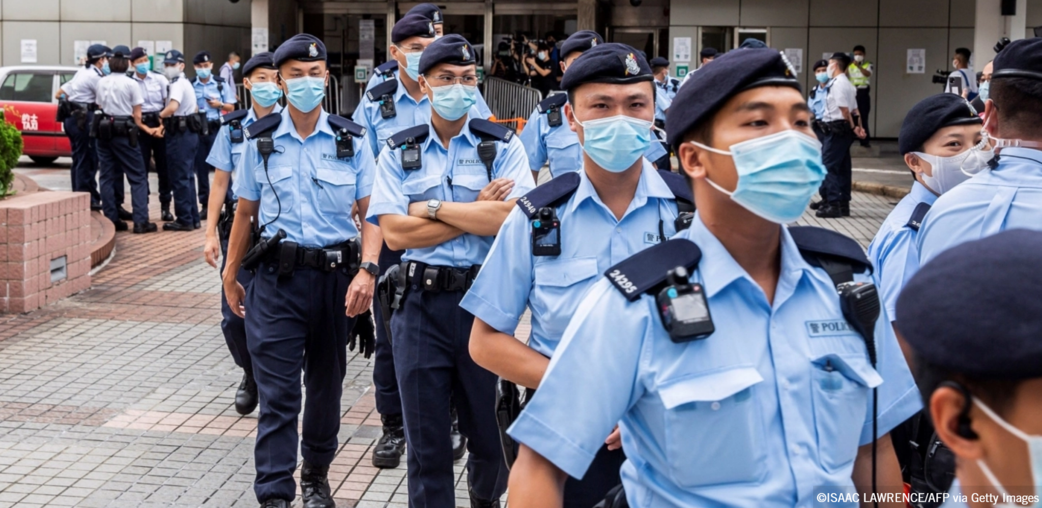 Police gather outside the High Court in Hong Kong on July 30, 2021, during the first trial conducted under the National Security Law imposed by China. Photo by ISAAC LAWRENCE/AFP via Getty Images.