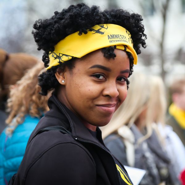 Amnesty International supporter wears yellow Amnesty bandana