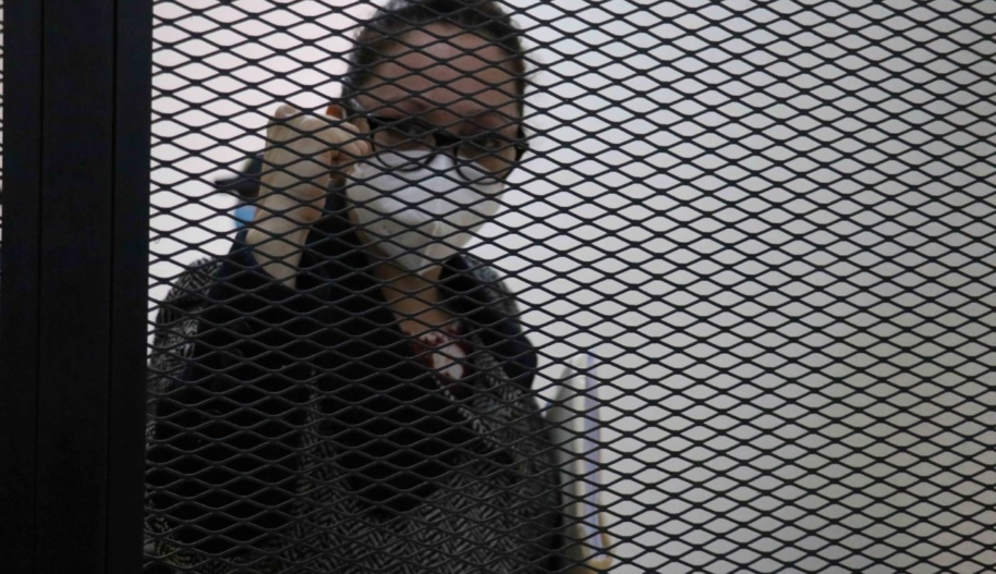 Virginia Laparra raises her fist behind bars