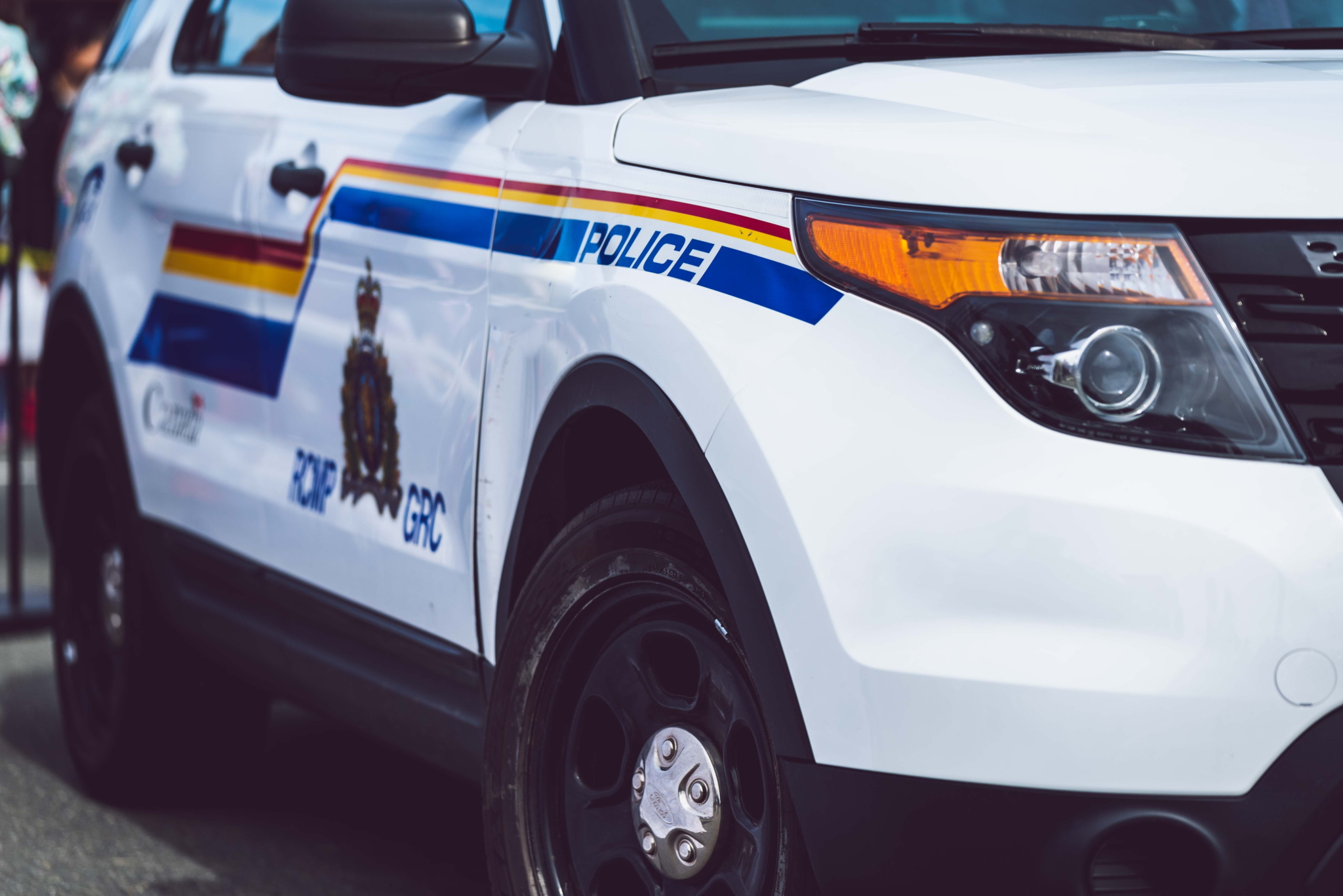 The front right bumper and headlight of a Royal Canadian Mounted Police cruiser