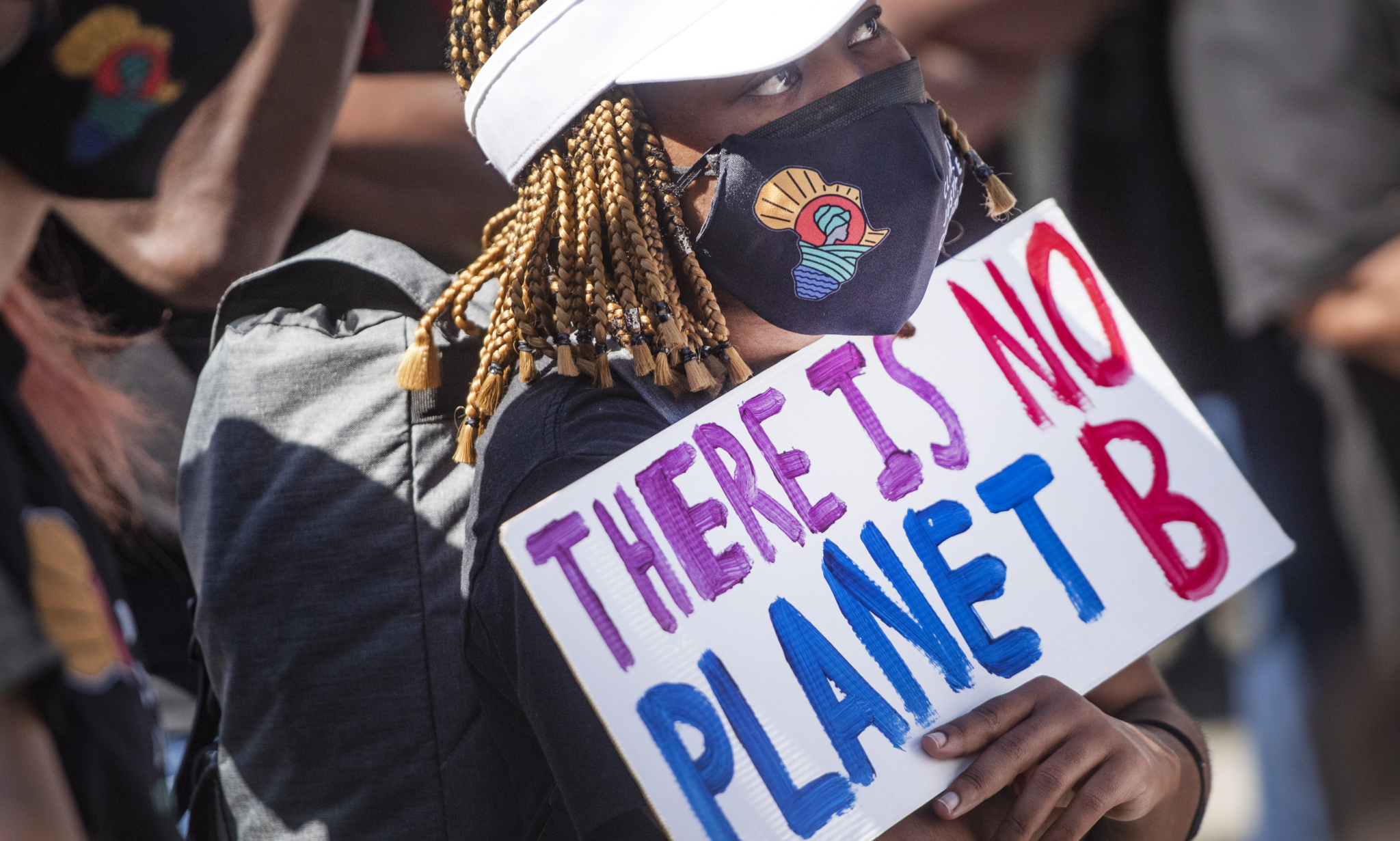 A woman at a rally in South Africa holds a sign that says: THERE IS NO PLANET B"