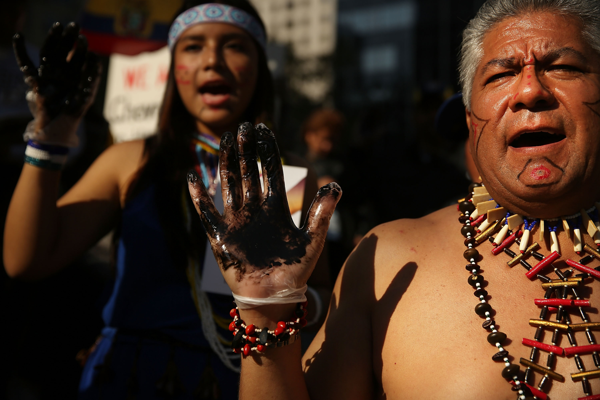 Indigenous protestors, with their hands painted black, protest oil contamination in Ecuador