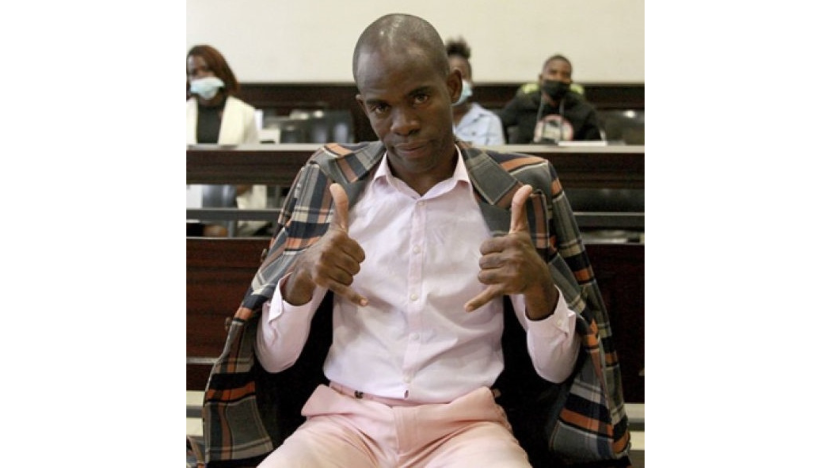 Tanaice Neutro seated in court with his two thumps up