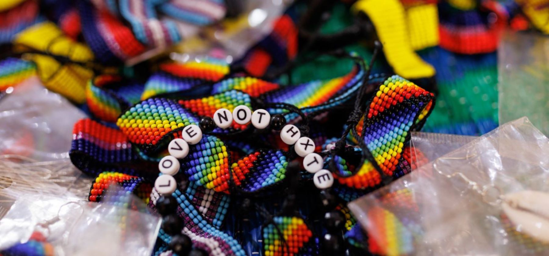 A woman identifying as a lesbian makes jewellery to sell whilst at a shelter for lesbian, bisexual, and queer women on April 24, 2023 in Kampala, Uganda.