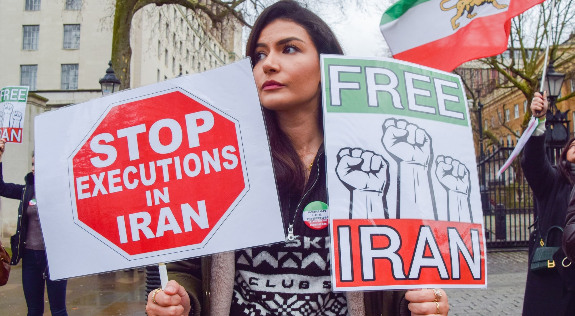 A protester holds 'Stop executions in Iran' and 'Free Iran' placards during a London demonstration on January 14, 2023. Demonstrators gathered outside Downing Street in protest against executions in Iran and support of freedom for Iran. (Photo by Vuk Valcic/SOPA Images/LightRocket via Getty Images)