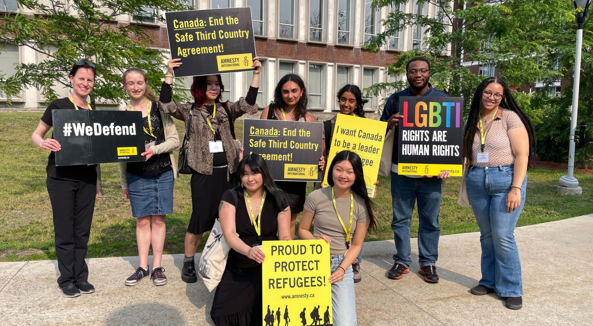 Amnesty youth leaders hold up signs