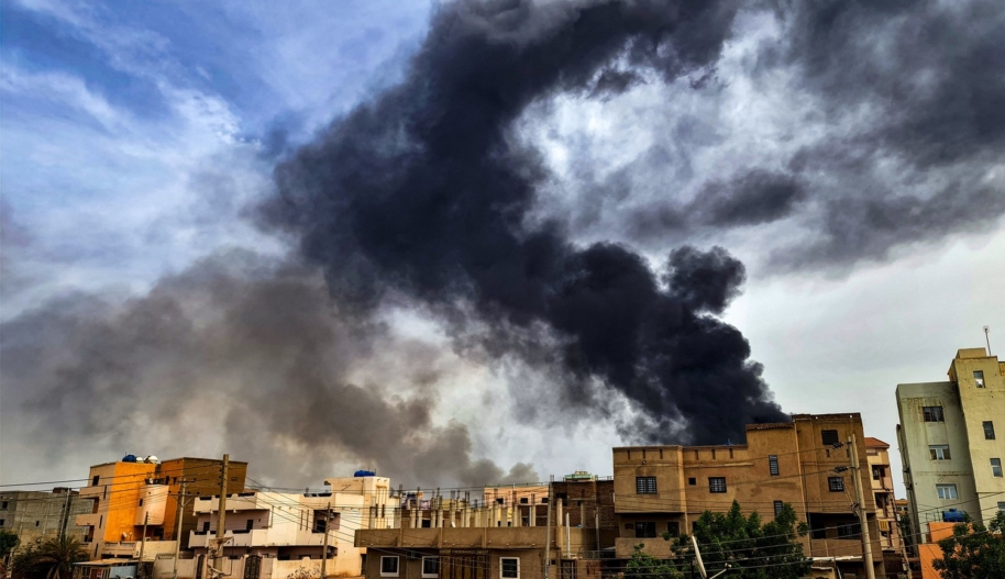 Smoke plumes billow from a fire at a lumber warehouse in southern Khartoum, Sudan.