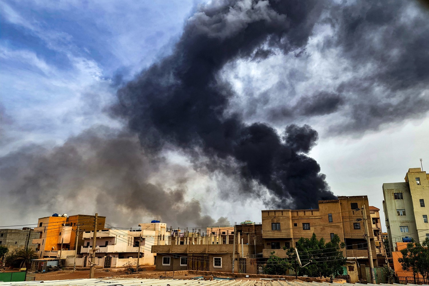 Smoke plumes billow from a fire at a lumber warehouse in southern Khartoum, Sudan.