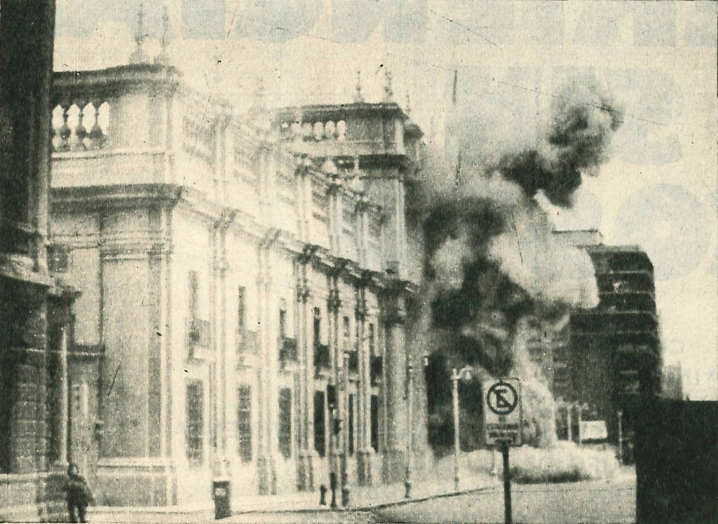 A black and white photo of the bombing of Chile's La Moneda presidential palace during the 1973 coup that saw incumbent President Salvador Allende killed and Augusto Pinochet rise to power.