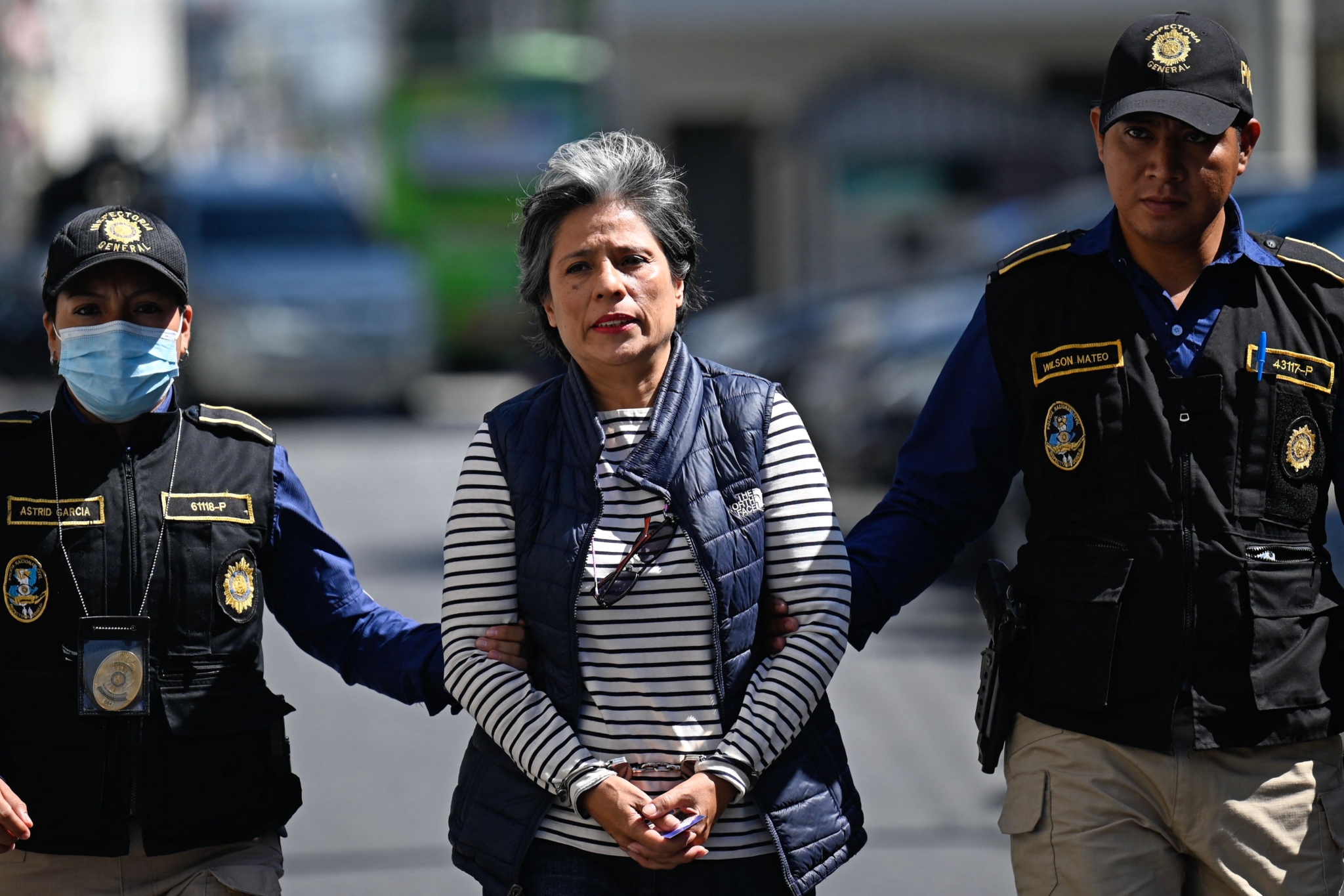 Lawyer and human rights defender Claudia Gonzalez is led away by police in handcuffs.