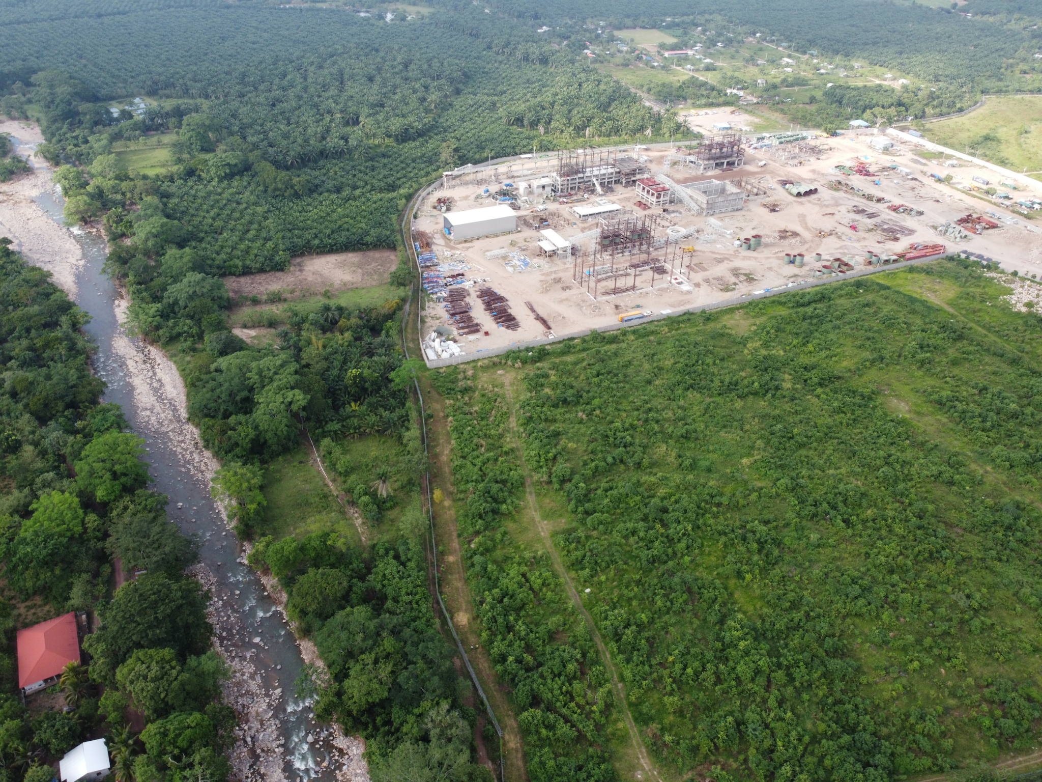 overhead shot of an iron ore operation beside a river