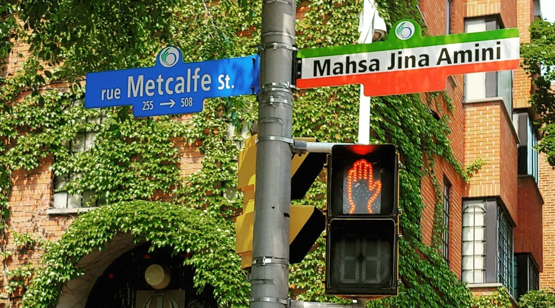 A street sign commemorating Mahsa Jina Amini is installed outside the former Embassy of Iran on Metcalfe street in Ottawa, June 2023 (c) private