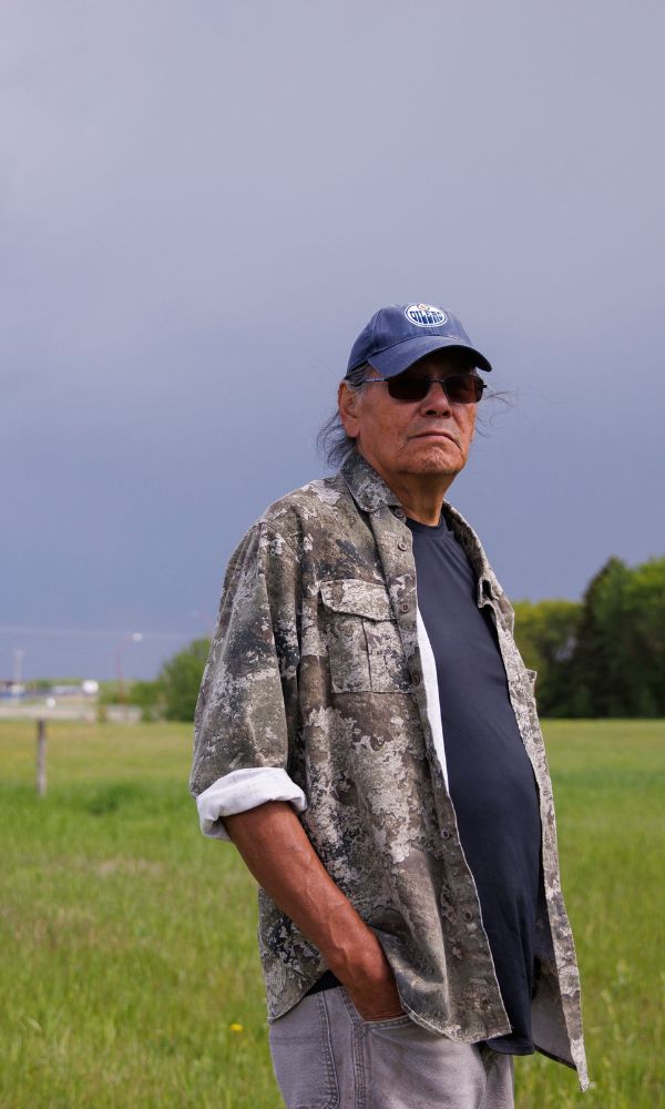 Brian Lee, the 68-year-old survivor of the Ermineskin Indian Residential School walks around the site where the school stood in Maskwacis, Alberta, on June 7, 2022. (Photo by Cole Burston/AFP via Getty Images)