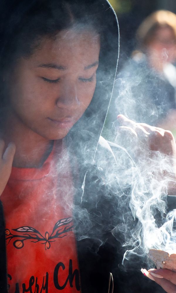 A student takes part in a smudging ceremony of a commemoration during the National Day for Truth and Reconciliation in Toronto, Canada, on Sept. 30, 2022. Canada marked its second National Day for Truth and Reconciliation on Friday to honor lost children and survivors of the notorious indigenous residential school system in the country. (Photo by Zou Zheng/Xinhua via Getty Images)