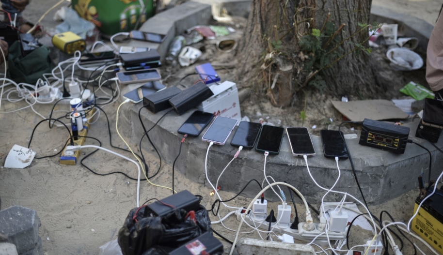 Social media companies must step up crisis response on Israel-Palestine as online hate and censorship proliferate. An image of phones being charged by portable charging stations at Palestinian Red Crescent center as people experience electricity shortages after Israeli attacks in Khan Yunis, Gaza on October 20, 2023. Photo by Abed Zagout/Anadolu via Getty Images.
