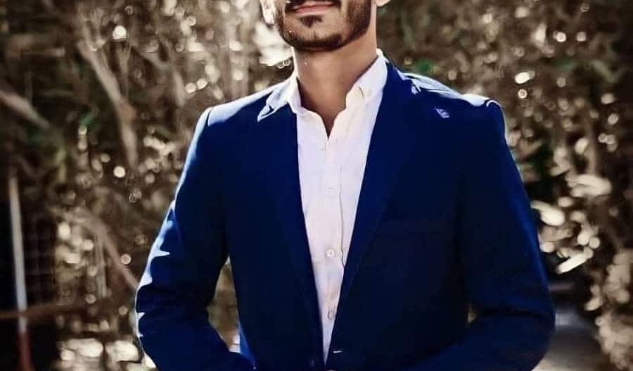 Sajjad al Iraqi wearing a dark blue suit over a white shirt
