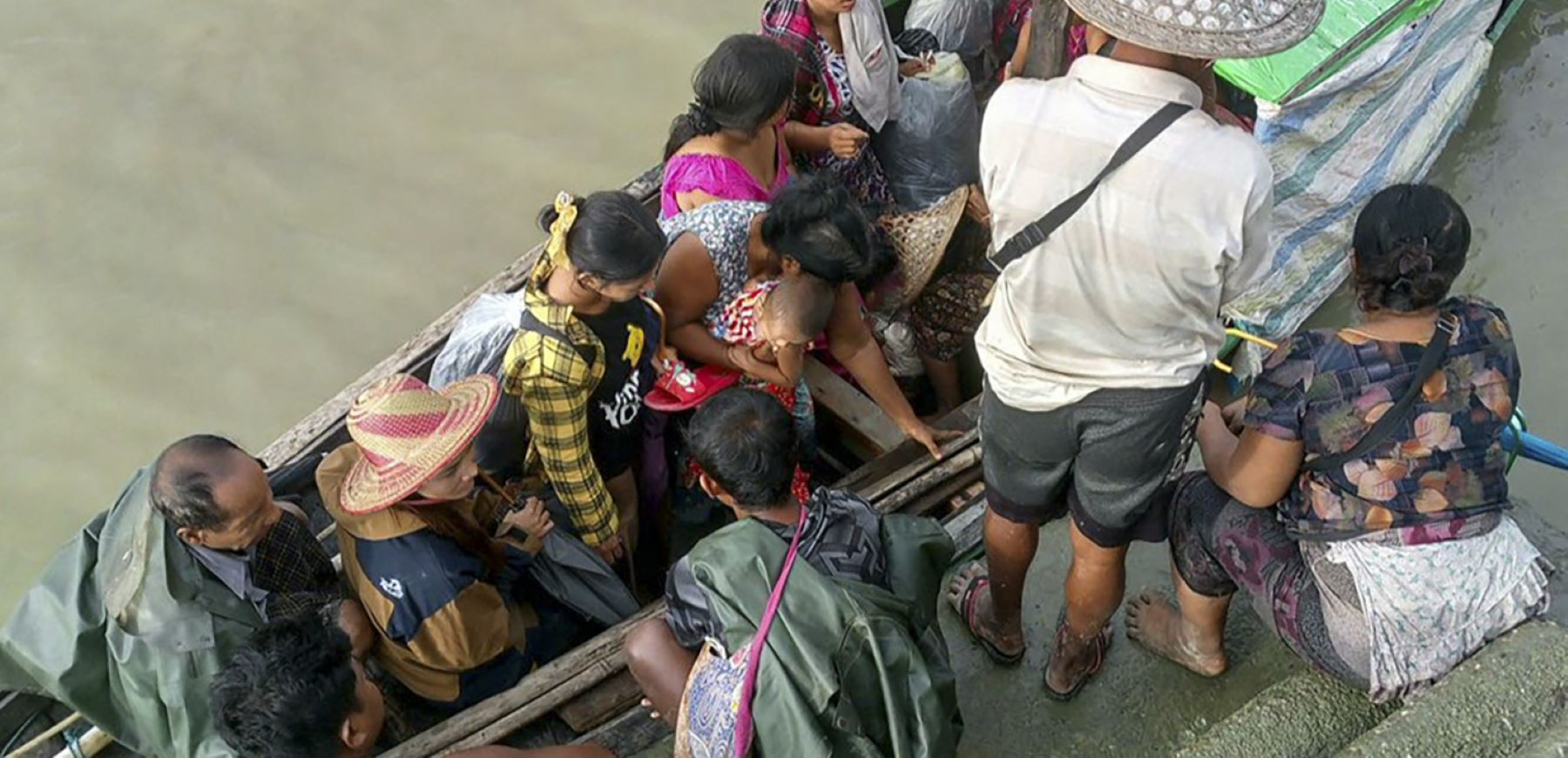 People flee from a village after renewed fighting between Myanmar's military and the Arakan Army (AA), an ethnic minority armed group, in Pauktaw Township in western Rakhine State on November 19, 2023. Ongoing clashes between the Arakan Army (AA) and the military "have resulted in the displacement of 26,175 people" across Rakhine, the United Nations Office for the Coordination of Humanitarian Affairs said in an update. Photo by STR/AFP via Getty Images.