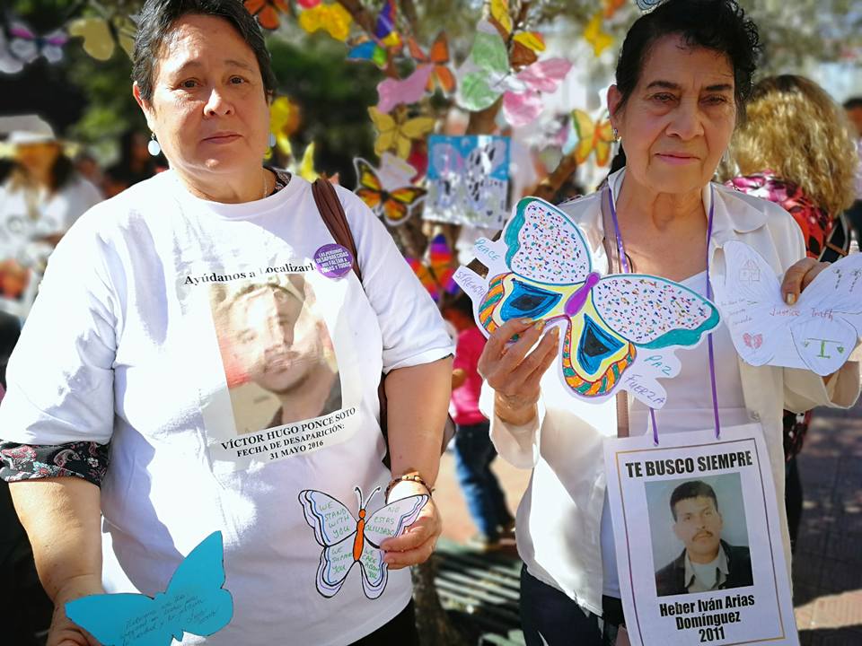 Mothers and sisters of the Disappeared with masks that read "Donde Estan? Where Are They?"