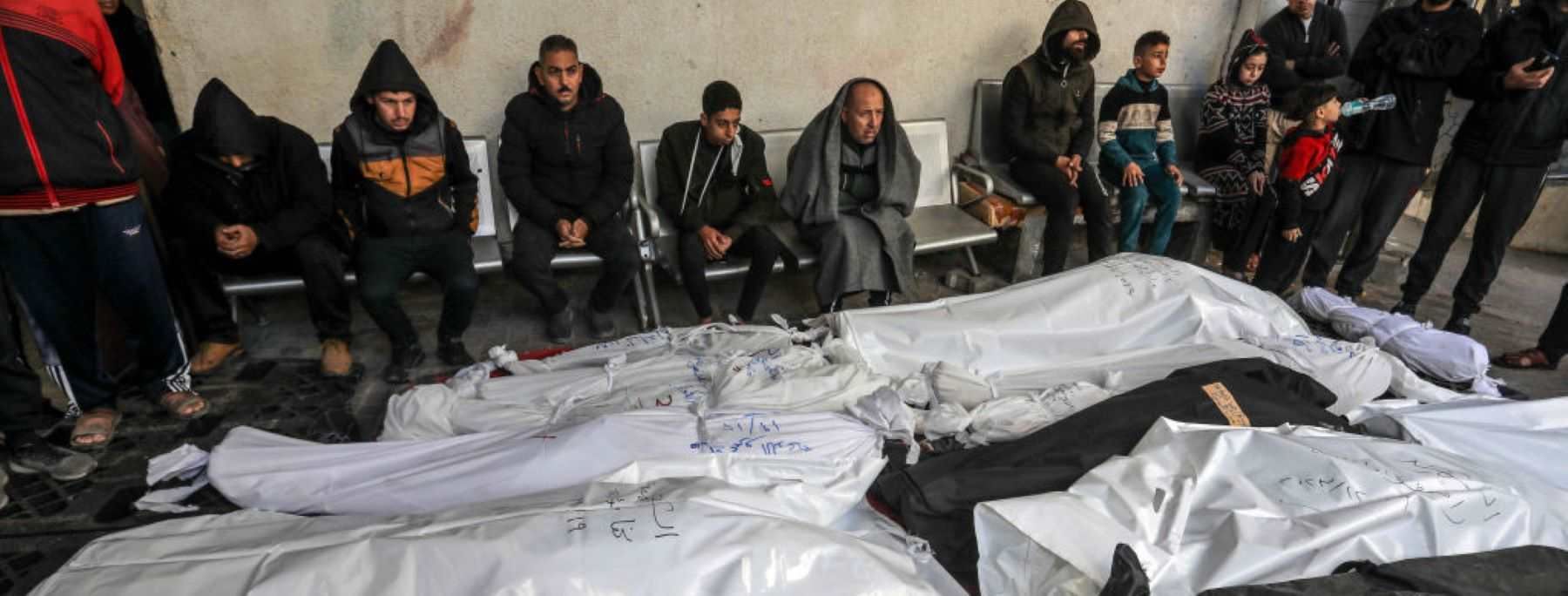 Relatives of the Palestinians died in Israeli attacks, mourn as they receive the dead bodies from the morgue of Nasser Hospital for burial in Rafah, Gaza on December 19, 2023. The journalist Adel Zorob was among the people killed in Rafah city. Photo by Abed Rahim Khatib/Anadolu via Getty Images.