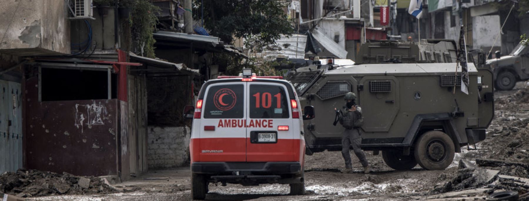An Israeli soldier gestures towards a Palestinian Red Crescent ambulance at the entrance of the Tulkarem refugee camp in Tulkarem, in the occupied West Bank, on January 17, 2024 during a military operation. Photo by MARCO LONGARI/AFP/Getty Images.