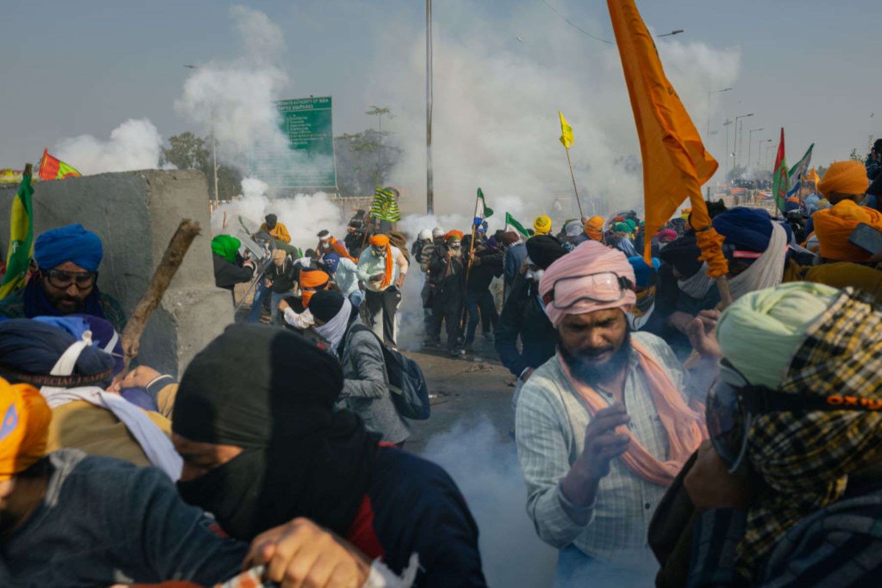 Farmers seek cover during a demonstration as they try to move towards Delhi on February 21, 2024 in Shambhu border area, India. Photo by Elke Scholiers/Getty Images