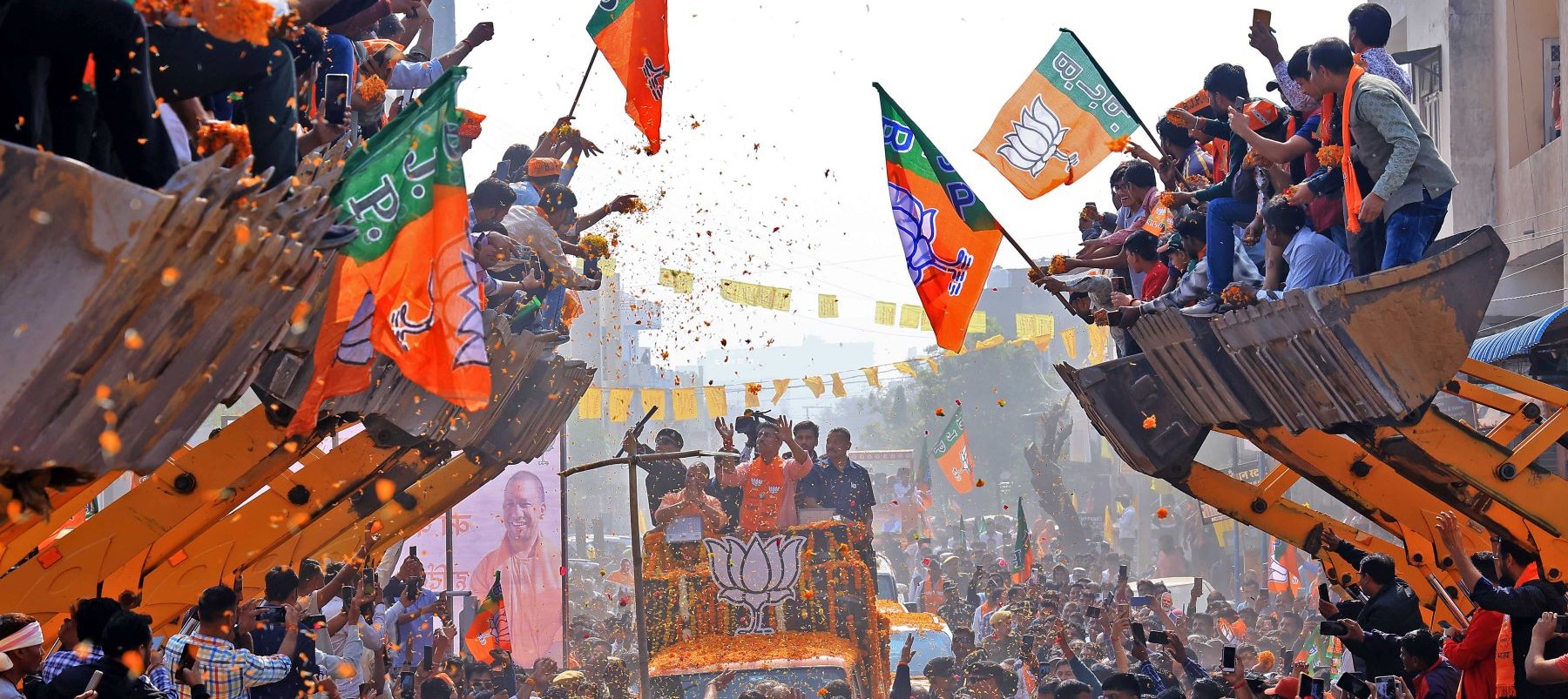 Uttar Pradesh Chief Minister Yogi Adityanath is participating in a roadshow aboard a bulldozer in support of BJP candidate Rajyavardhan Singh Rathore from the Jhotwara constituency ahead of the Rajasthan Assembly elections in Jaipur, Rajasthan, India, on November 23, 2023. Photo by Vishal Bhatnagar/NurPhoto via Getty Images.