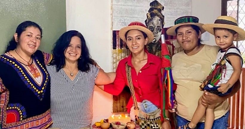 Deyanira holds her son in a photo with other threatened Colombian defenders
