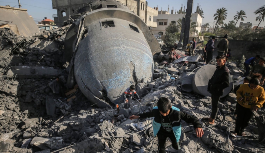 Palestinian children are walking past the rubble of the al-Bukhari mosque in Deir al-Balah, central Gaza Strip, on March 2, 2024, following an overnight Israeli air strike amid continuing battles between Israel and the Palestinian militant group Hamas. Photo by Majdi Fathi/NurPhoto via Getty Images.