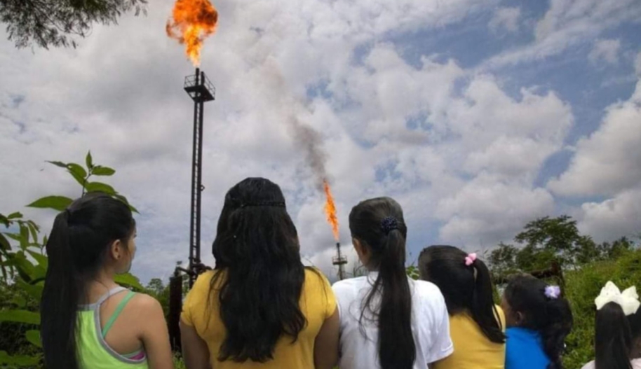 Leonela and the Amazonian girls observe gas flares that still operate, belching out harmful emissions, despite a court ruling. Photo credit: @UDAPT