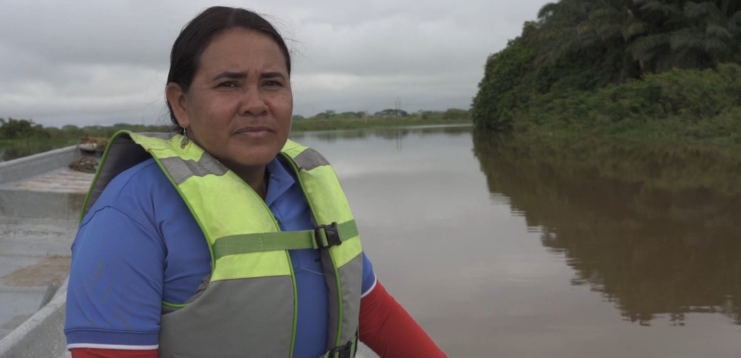Water defender Yuly Velasquez travels in a boat up the river