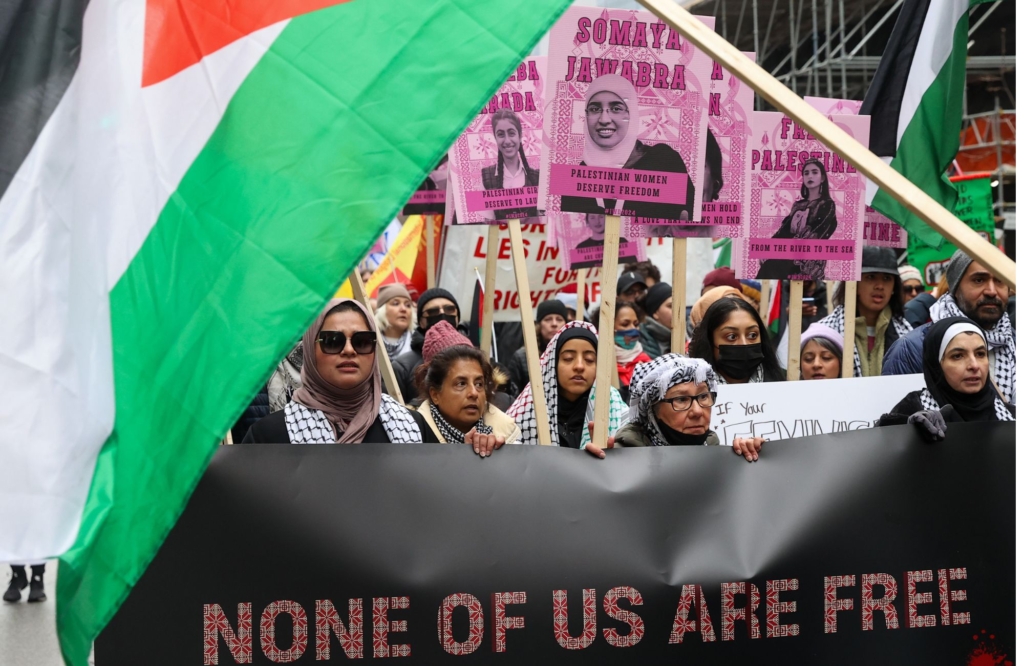 People holding Palestinian flags and portraits of Palestinian women attend Toronto's annual International Women's Day (IWD) march on March 2, 2024 in Ontario, Canada. (Photo by Mert Alper Dervis/Anadolu via Getty Images)