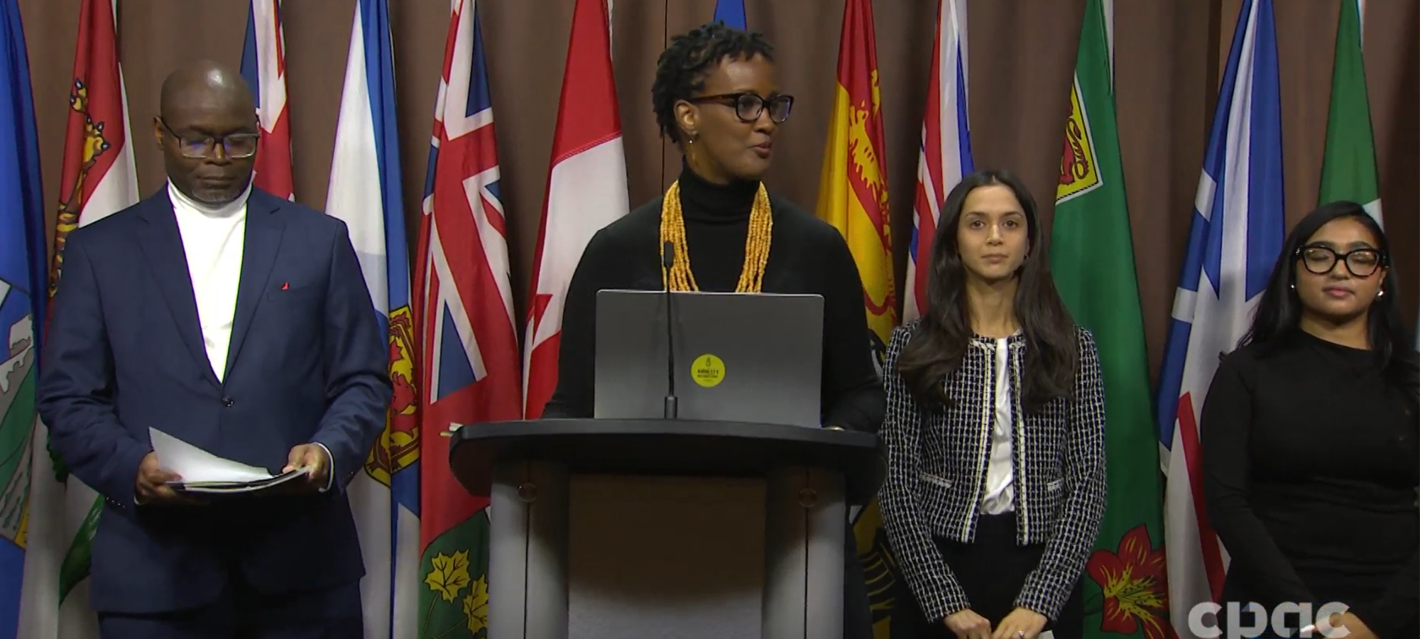 Amnesty International Canada secretary general Ketty Nivyabandi speaks at podium during press conference in Ottawa