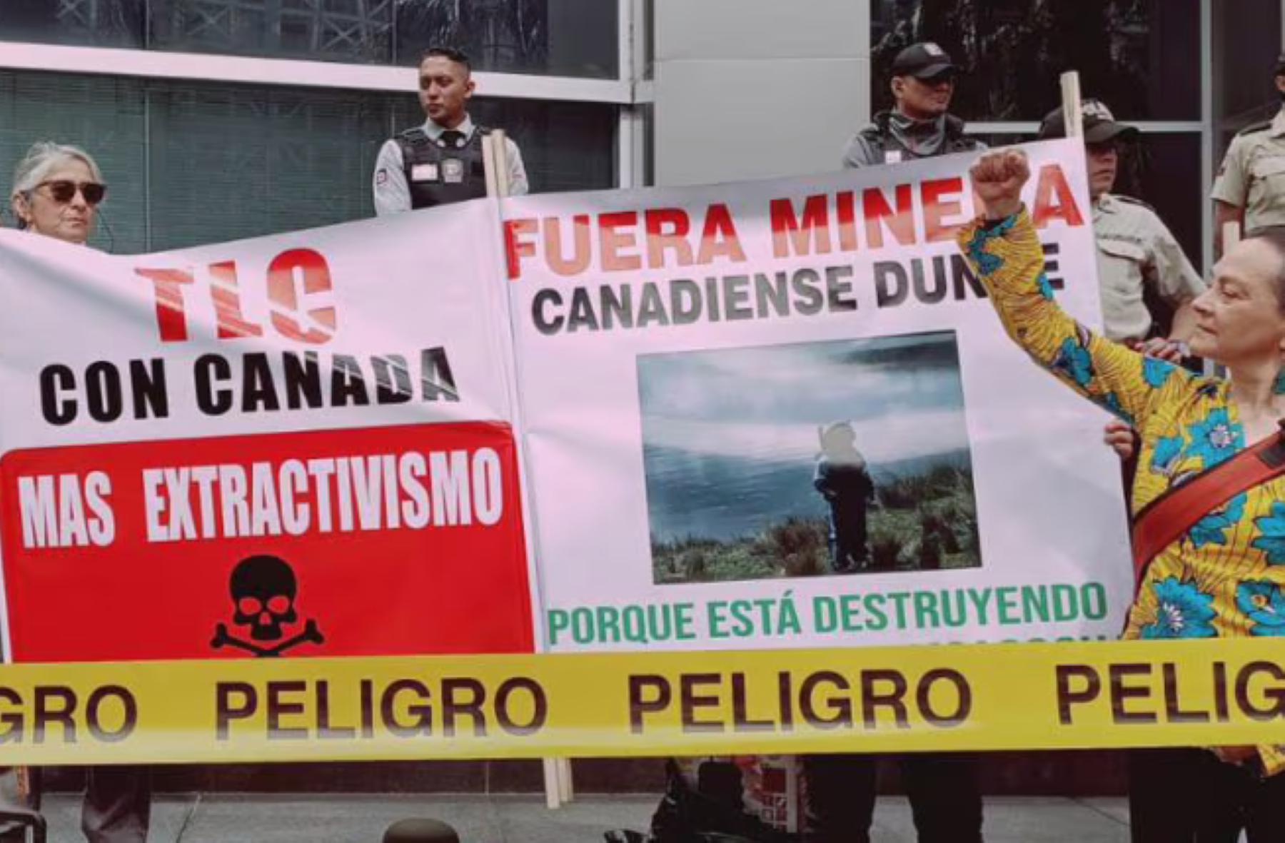 Danger reads the yellow tape during a protest outside Canada’s Embassy in Quito on March 4. Free Trade Agreement with Canada = More extractivism. Canadian mining out, reads the banner. Photo: Acción Ecológica @AcEcologic